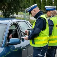 Policjant kontroluje dokumenty kierowcy, który może być bliski pobicia rekordu punktów karnych.
