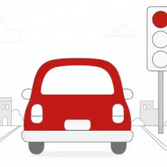 Czerwony samochód zbliża się do skrzyżowania, gdzie sygnalizator pokazuje czerwone światło. Zastanawiasz się, ile punktów karnych za przejazd na czerwonym świetle grozi w takiej sytuacji?
