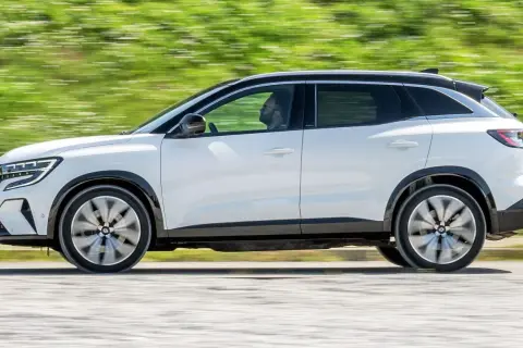 Biały Renault Austral w ruchu, z widocznym kierowcą. Jego dynamiczna sylwetka i nowoczesne linie podkreślają jego wymiary.
