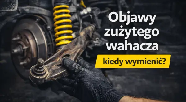Mechanik w czarnej rękawicy trzyma zużyty wahacz w samochodzie, obok żółtej sprężyny amortyzatora.