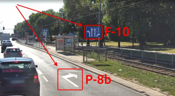 Droga z wyznaczonym buspasem. Znak F-10 informuje o pasach ruchu, a P-8b wskazuje kierunek jazdy.