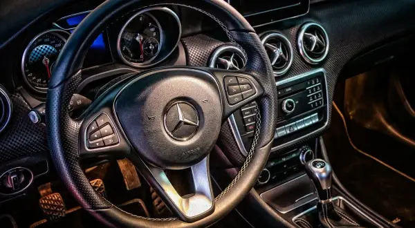 Wnętrze Mercedesa z kierownicą i deską rozdzielczą. Idealne do wynajem samochodu powyżej 150 tys. km.