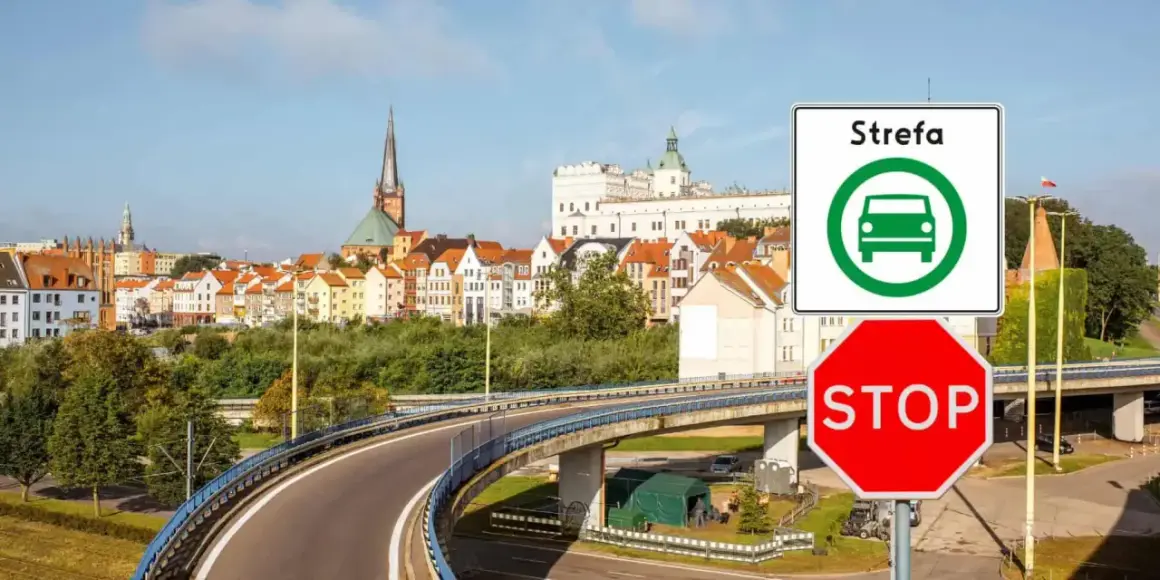 Znak "Strefa czystego transportu Szczecin" i czerwony znak STOP przed panoramą miasta.